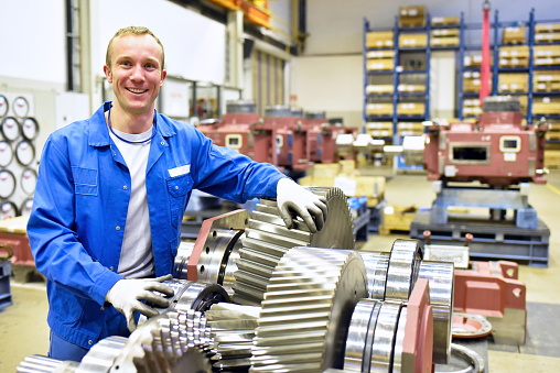 portrait of young cheerful workers in mechanical engineering