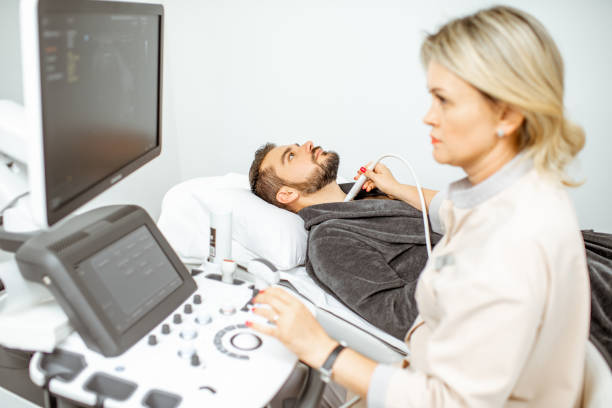 istock Doctor examining men's thyroid with ultrasound 1169154478
