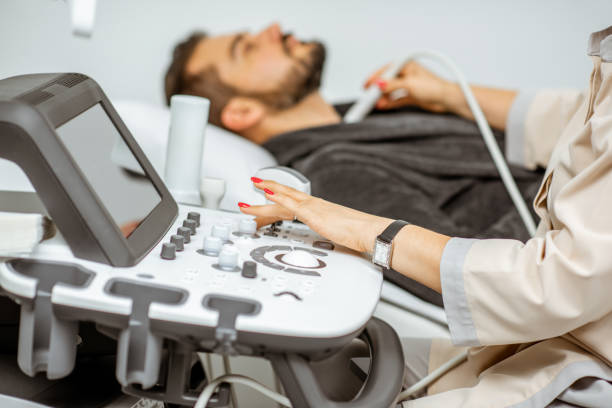 istock Men examining his thyroid with ultrasound 1169154487