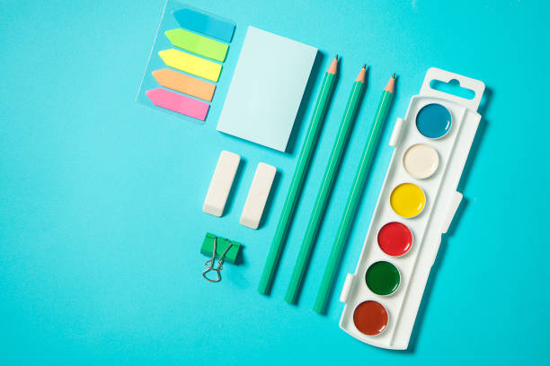 istock Back to school mock up. Flat lay composition with a watercolor, pencil, sticker, eraser. Isometric concept on blue background. Pop art. School supplies. overhead. Branding mock up stationery 1169155603