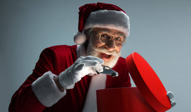istock Santa Claus packing car in opened gift box 1169156073