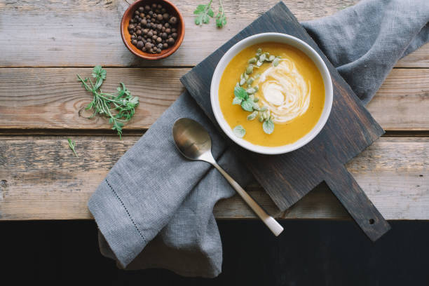 istock Pumpkin cream soup in bowl 1169157124