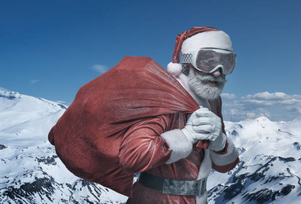 istock Senior Santa Claus in mountains with sack 1169157914