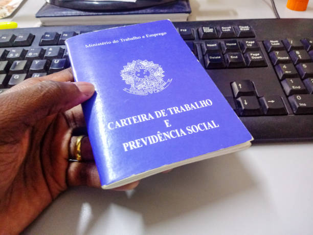 istock Man's holding Brazilian document work and social security with a keyboard in the background 1169158937