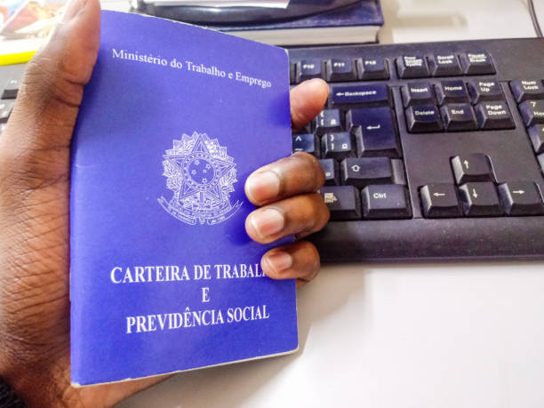 istock Man's holding Brazilian document work and social security with a keyboard in the background 1169158941