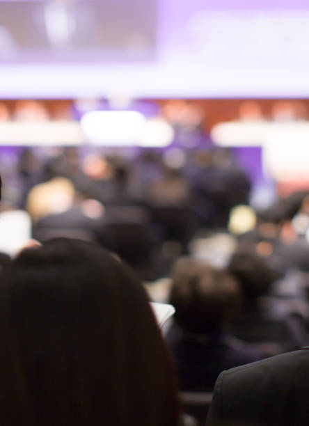 istock Conference with panel speakers on stage during debate. Presenters at corporate seminar talking to audience.  Business leadership CEO lecture during convention. Executive board of directors. 1169159347