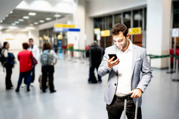 istock Businessman using mobile on airport 1169160330