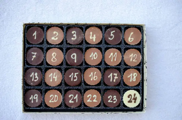 Christmas gift box with 24 sweet chocolate bonbons with numbers