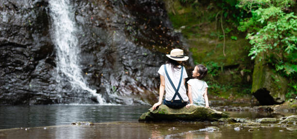 istock Mother and daughter play in mountain stream 1169161945