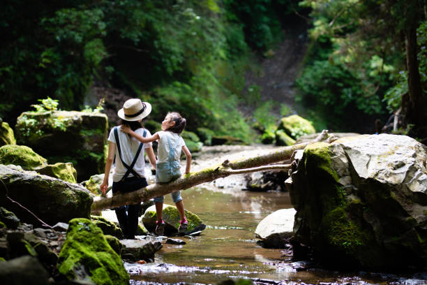 Mother and daughter play in mountain stream