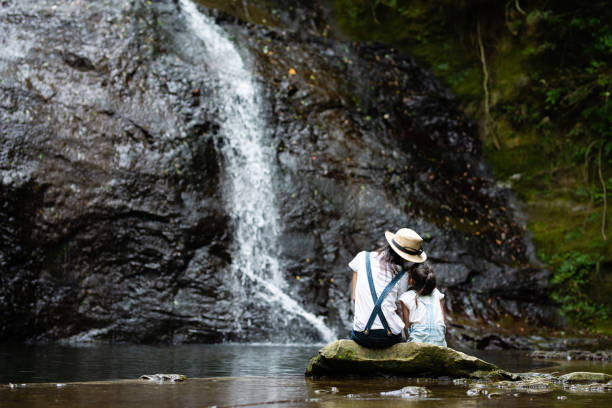 istock Mother and daughter play in mountain stream 1169162017