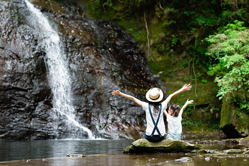 Mother and daughter play in mountain stream