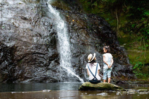 istock Mother and daughter play in mountain stream 1169162115