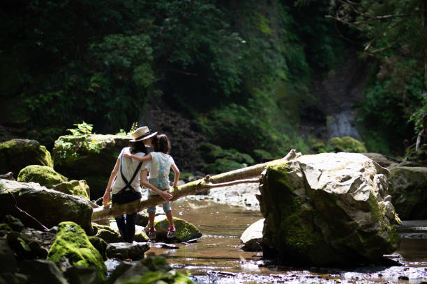 istock Mother and daughter play in mountain stream 1169162116