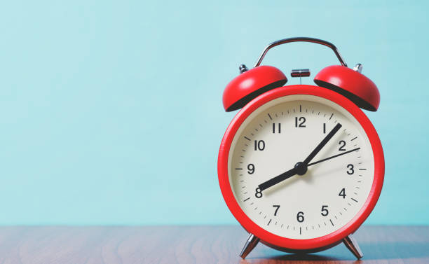 istock Red alarm clock on light blue background. 1169162494