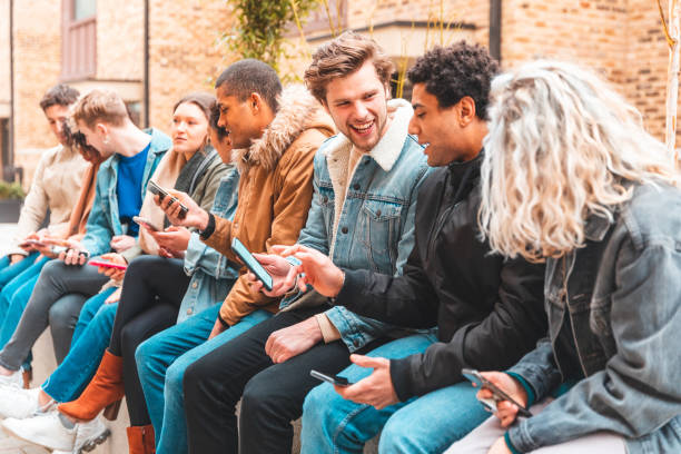 istock Multicultural group of friends using smartphone and having fun 1169162518