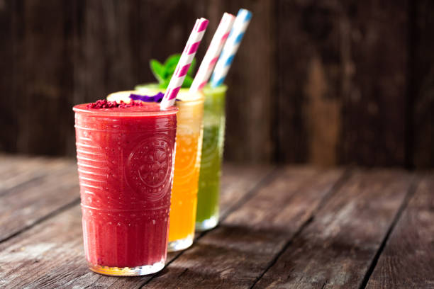 istock Three delicious smoothies aligned in order served on the wooden table 1169163524