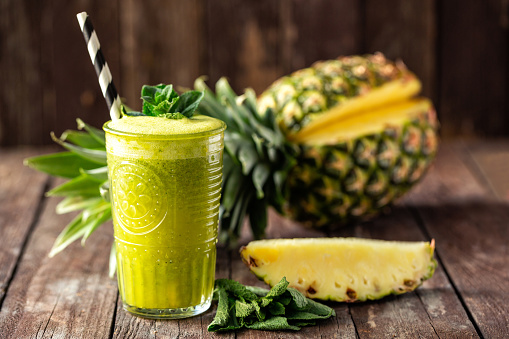 Healthy tropical smoothie with followed by astonishing pineapple decoration, tropical fruit slices