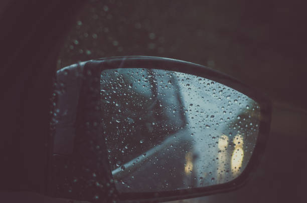 istock bad weather on the road in the car mirror 1169166300