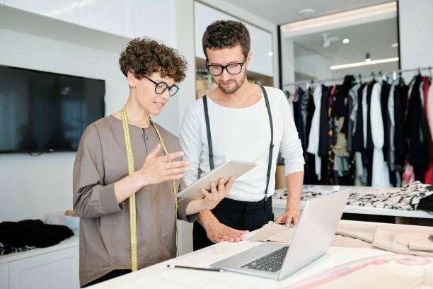 istock One of young tailor with tablet making presentation of creative ideas 1169167472