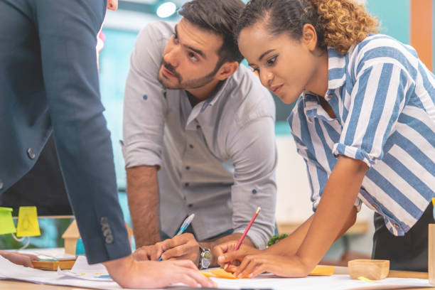 istock Team of young Architect Designer is brainstorming in office 1169169188