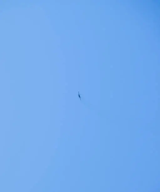 Photo of The fighter in the blue sky. Flying an airplane