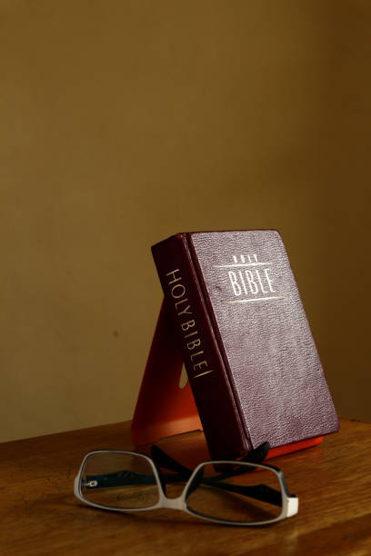 Photo of a Holy Bibles on a table and eyeglasses