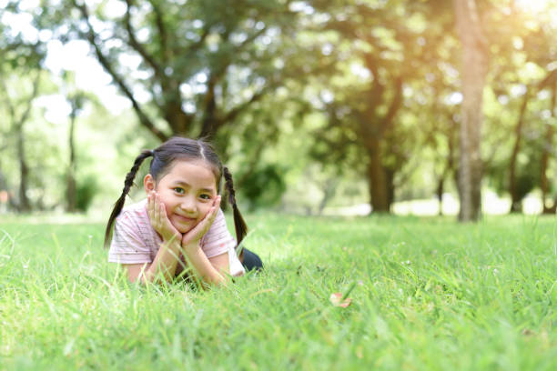 istock Little girl on green grass 1169171615