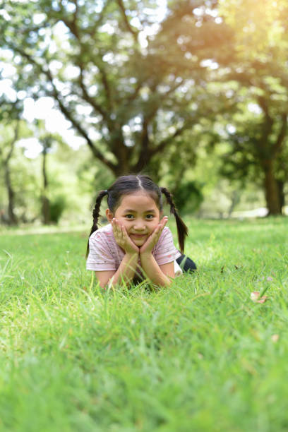 istock Little girl on green grass 1169171618