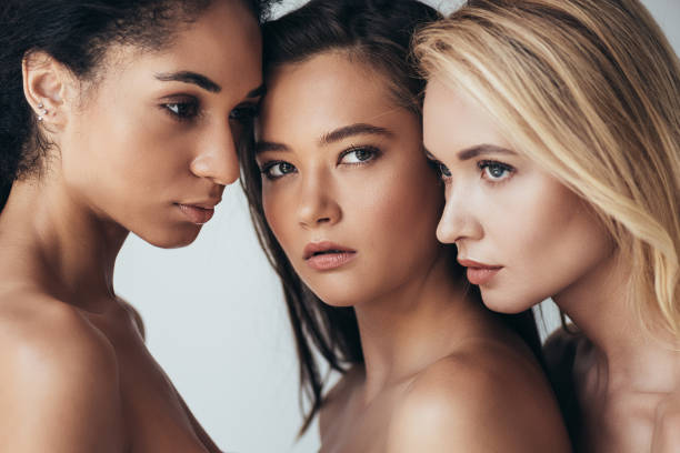 istock three attractive multiethnic young women looking away isolated on grey 1169172794
