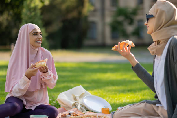 istock Muslim students eating pizza and talking after classes 1169173135