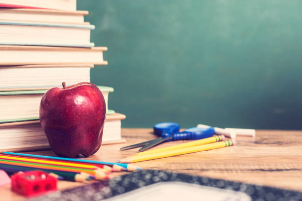 gruppe von schulbedarf auf holztisch mit tafel. - textbook book apple school supplies stock-fotos und bilder