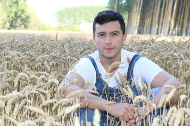 istock Cute farmer in denim overalls 1169174395