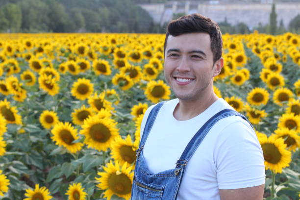 istock Cute ethnic farmer in sunflower field 1169174432