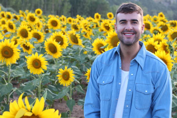 istock Cute farmer in sunflower field 1169174441