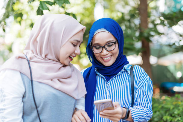 istock Women in Malaysia using mobile phone 1169174929