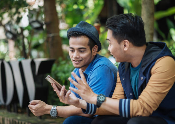 istock Friends using mobile app on smartphone 1169175148