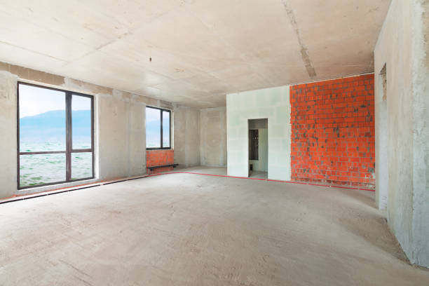 istock Construction site of residential apartment building interior in progress with panoramic windows and red brick wall 1169175576
