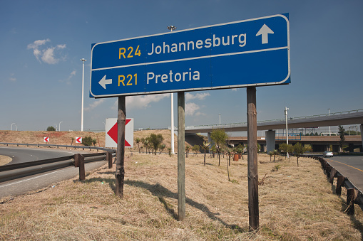 Road sign directions by car from or Tambo airport to Johannesburg and Pretoria. South Africa,