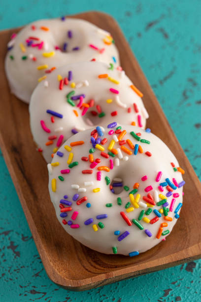 istock Cake Donut with White Frosting and Multicolored Sprinkles 1169175789