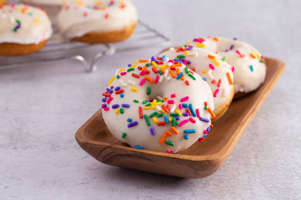 istock Cake Donut with White Frosting and Multicolored Sprinkles 1169175817