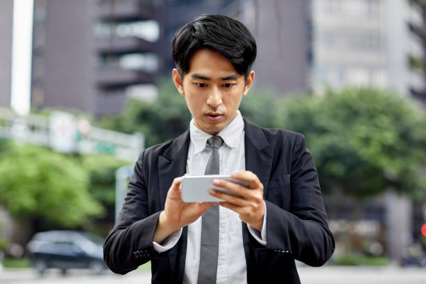 istock Young businessman using mobile phone in city 1169177122