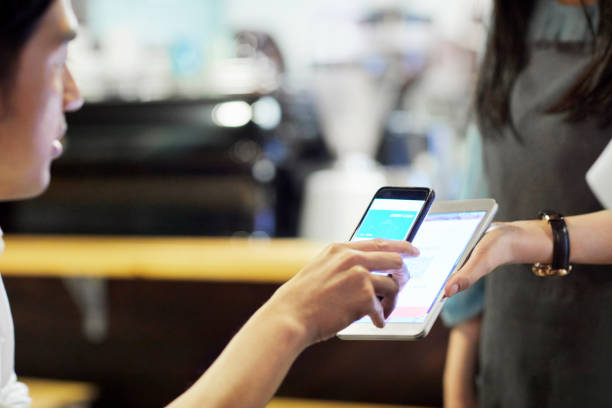 istock Waitress receiving payment through mobile phone 1169177238