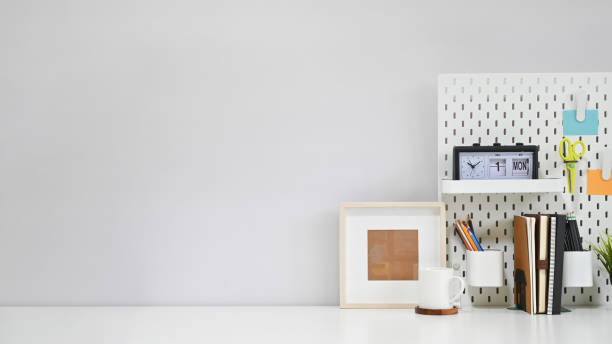 istock Workspace office supplies, coffee and photo frame on white creative table with copy space. 1169177717