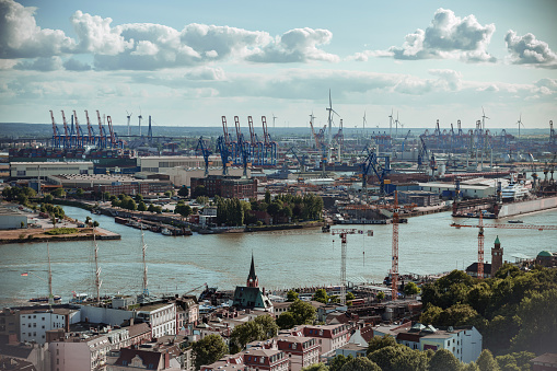 Wide panoramic view on the cranes of industrial port in Hamburg