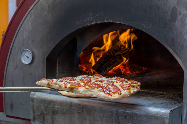 istock Cooking pizza in a wood-burning oven 1169180059