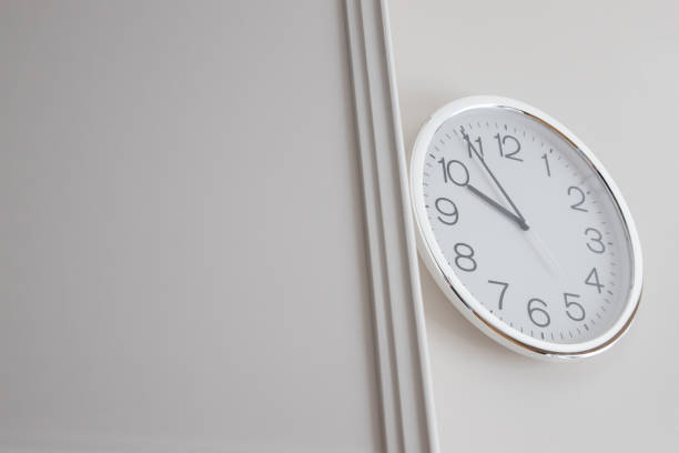 istock silver clock wall on white luxury wall.  show time in late morning. 1169181620