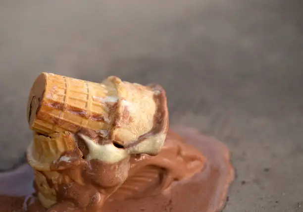 Photo of An Ice Cream Cone Knocked Over and Melting