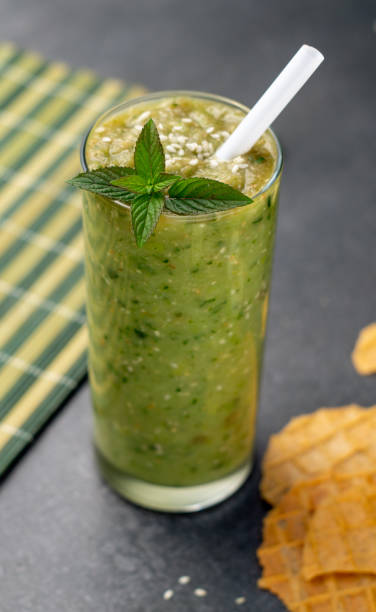 istock Vegetable green smoothie in a glass on a dark background 1169185587