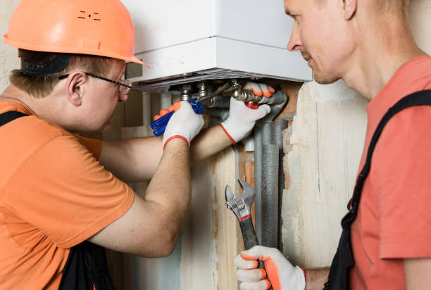 istock The worker is installing the gas boiler pipes. 1169185710